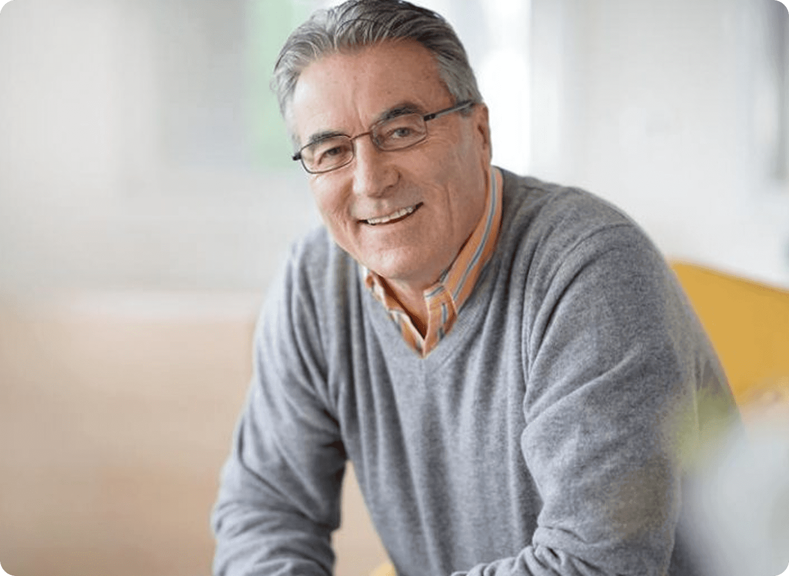 Smiling man in glasses and sweater